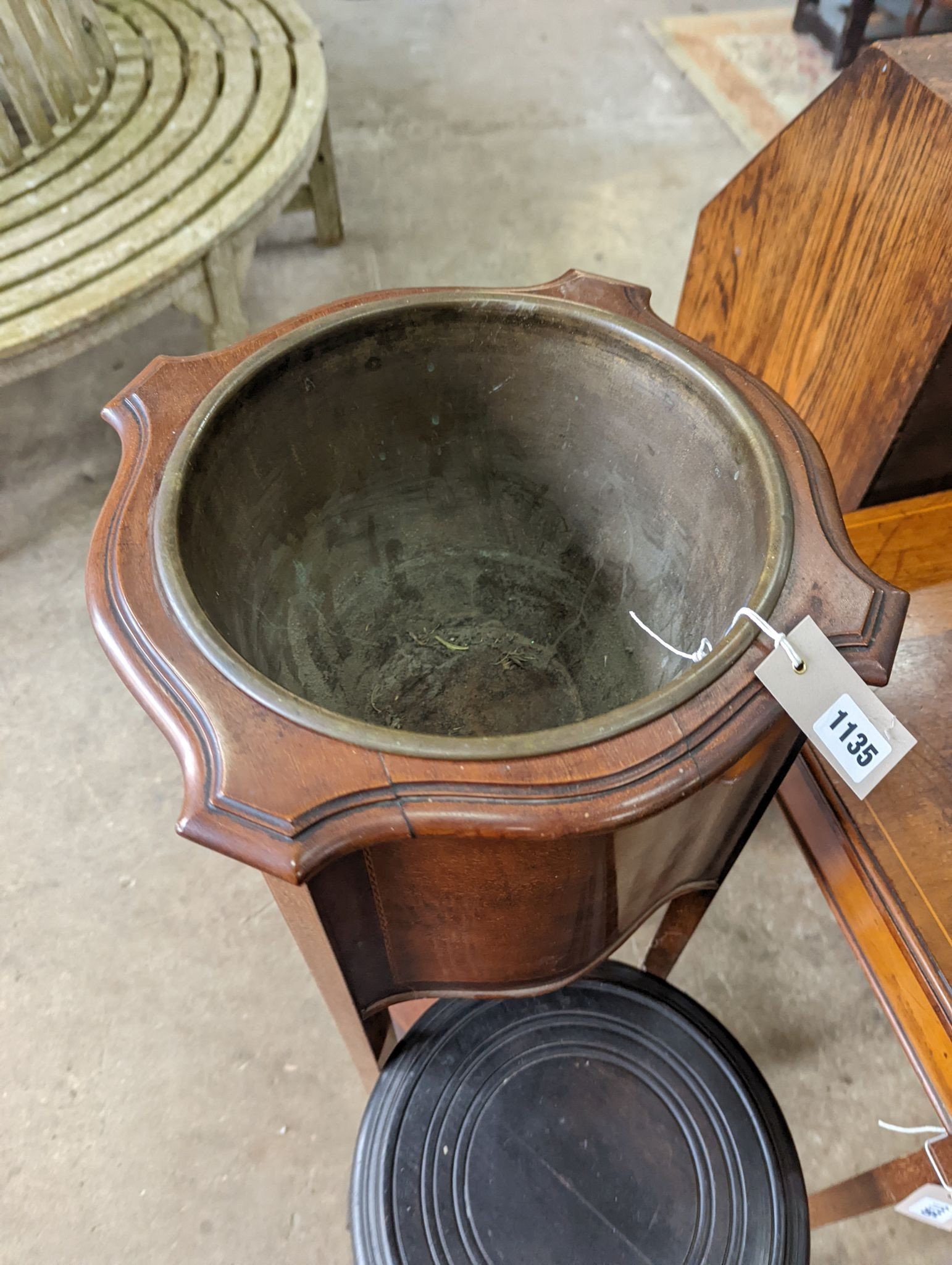 An Edwardian inlaid mahogany jardiniere with brass liner, height 99cm together with a small ebonised plant stand